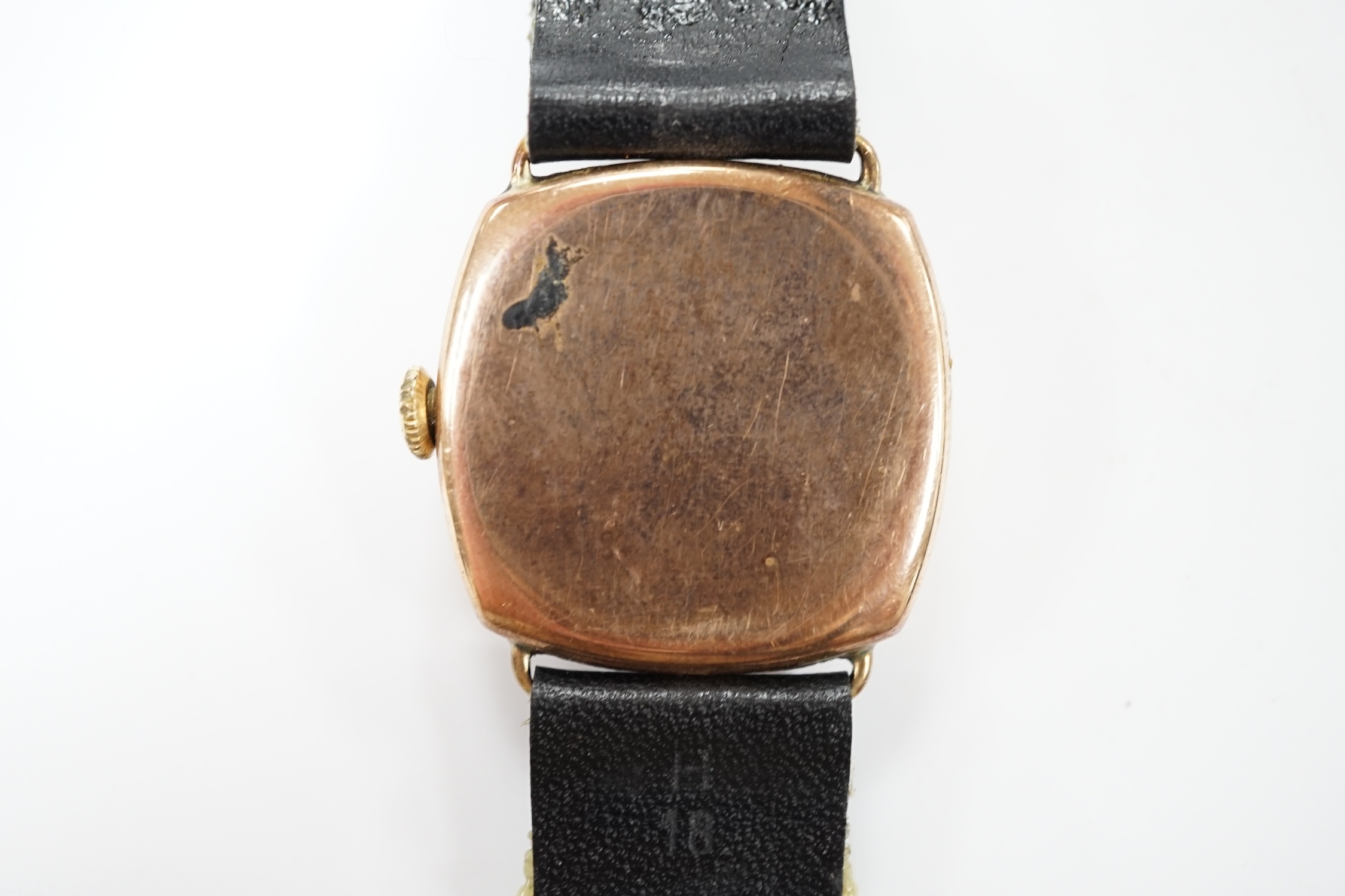 A gentleman's 1930's yellow metal manual wind wrist watch, with Arabic dial and subsidiary seconds, on a later leather strap. Condition - poor